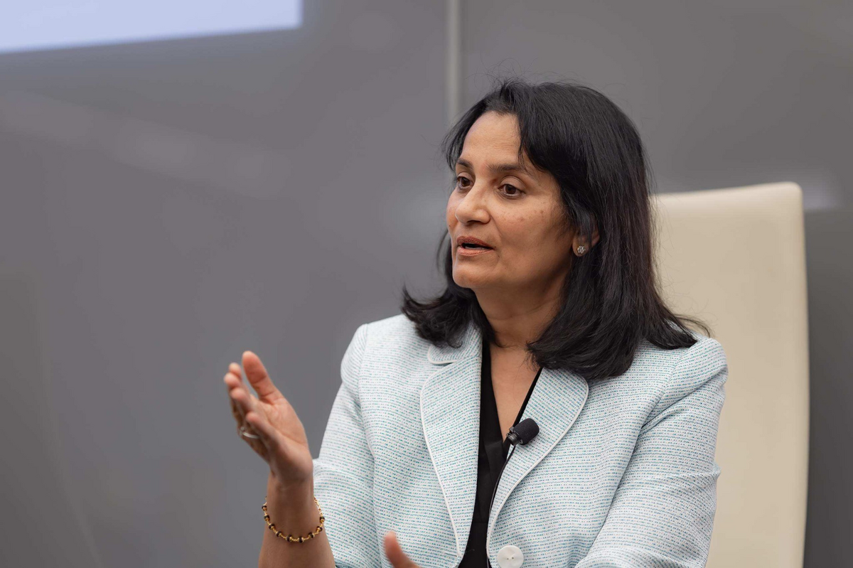 A healthcare executive speaking during a summit discussion