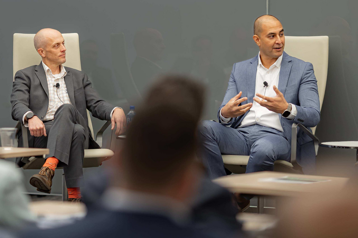 Two panelists in conversation before an audience