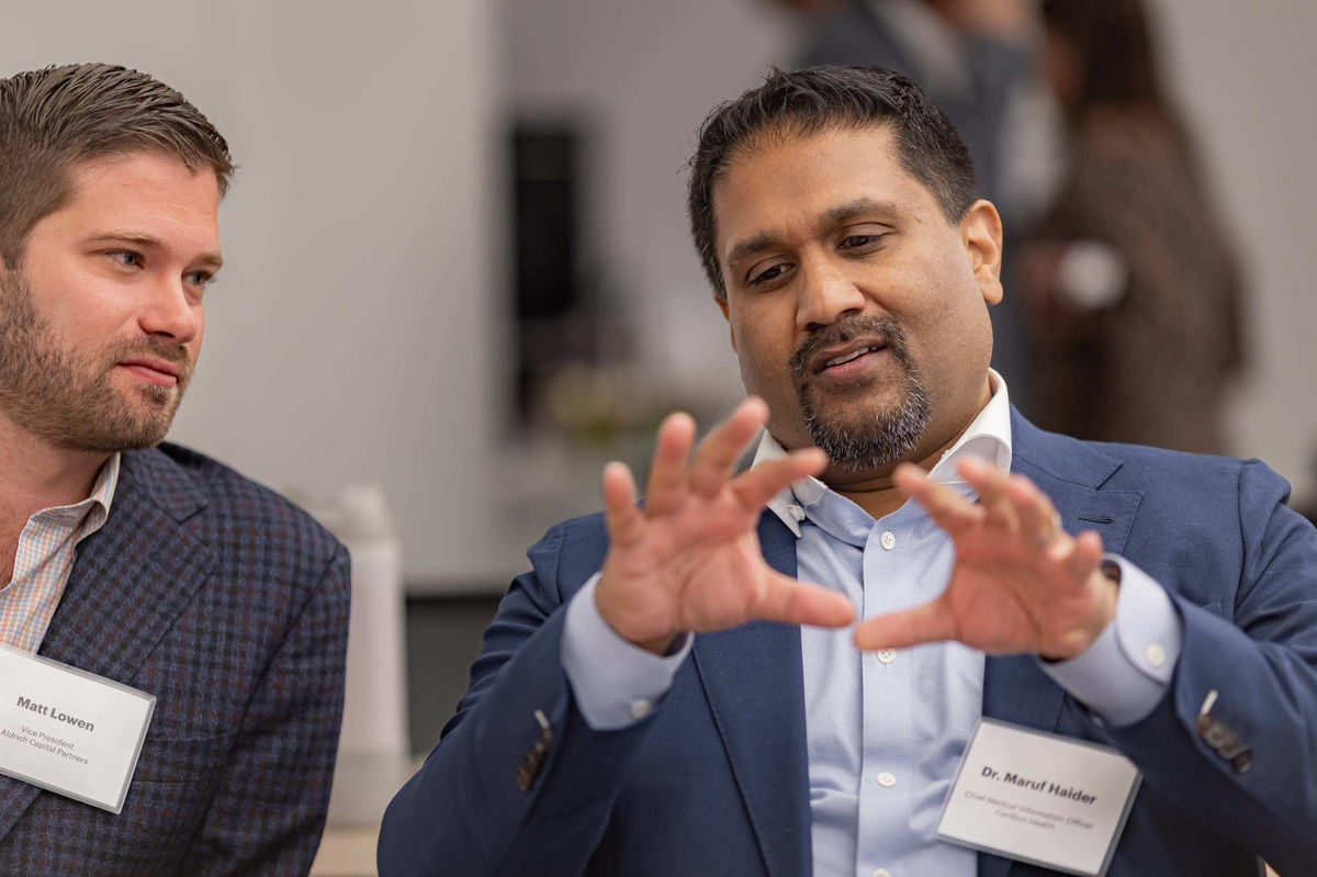 Two attendees discussing healthcare innovation