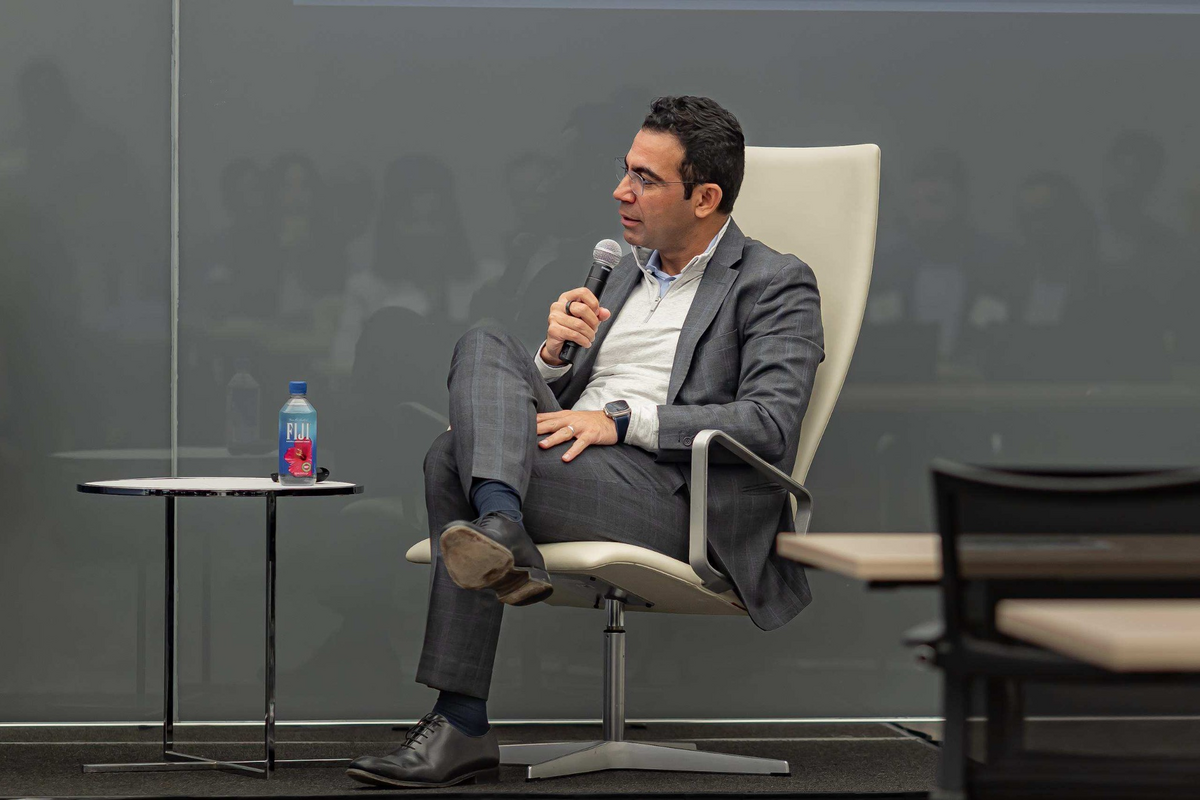 A speaker addressing attendees during a fireside conversation